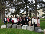 Students and graduates of the Diplomatic School in front of the rock from Armenia as part of the "Rebirth" symbol representing pieces from all member states